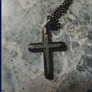 A black diamond cross necklace one ct